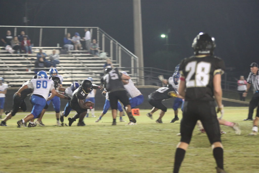 #19 Julian Birchette with the carry as #75 Nolan Moore blocks for him.
