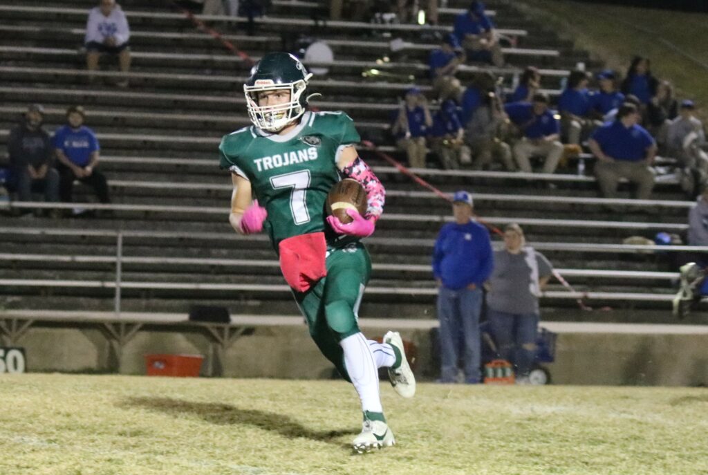 #7 Nick Sanderson turns the corner on his way to a Trojan Touchdown.