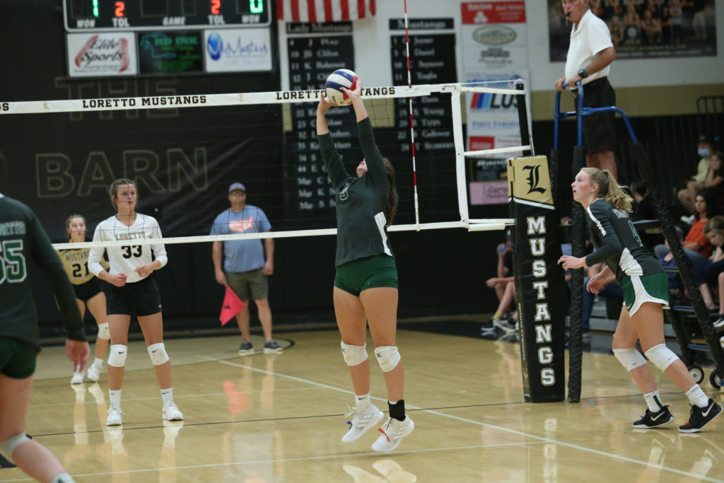 Kaycee Luker sets a ball during a match against Loretto.
