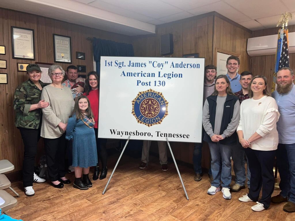    Coy Anderson’s family, including his wife Betty, daughters Mary Lauren, Jennie, Bonnie, and Lottie, and his grandsons, attended the ceremony on Saturday. They are pictured above with the sign that will be placed on the American Legion building in Waynesboro.